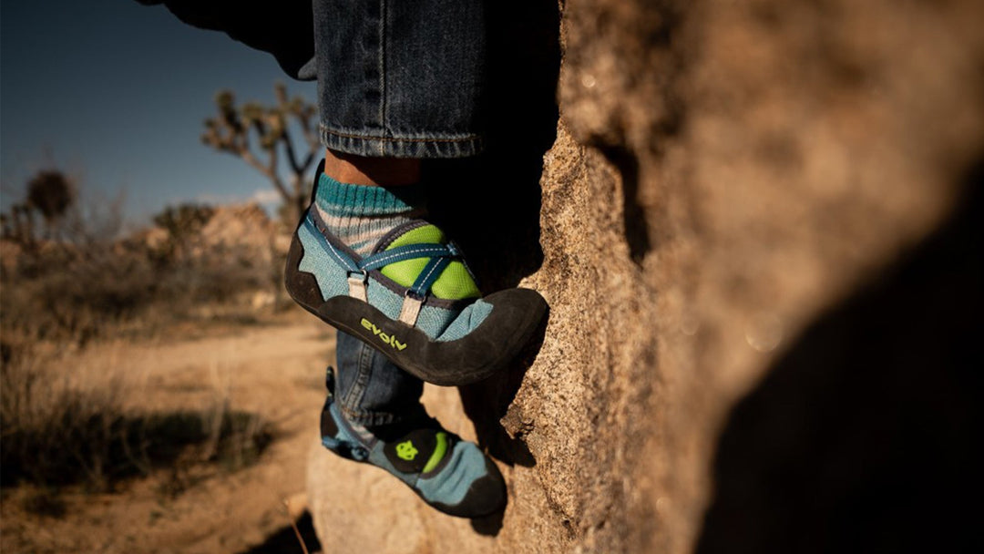 close up of a young child's rock shoes while climbing outdoors