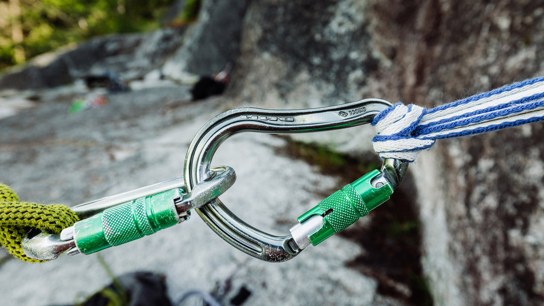 A locking carabiner being used for a rock climbing anchor