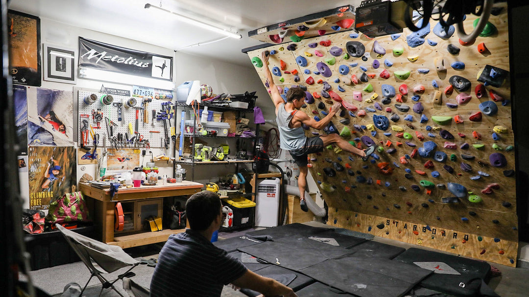A rock climber trains on a home climbing wall