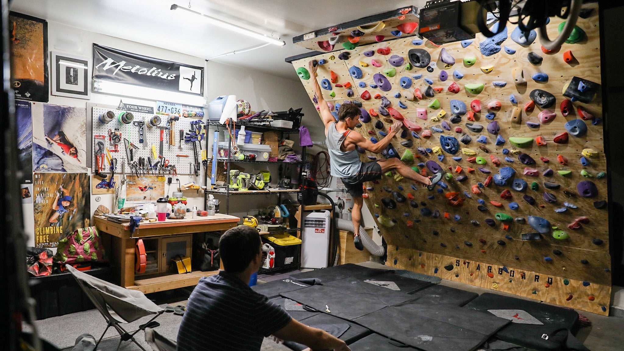 A rock climber trains on a home climbing wall