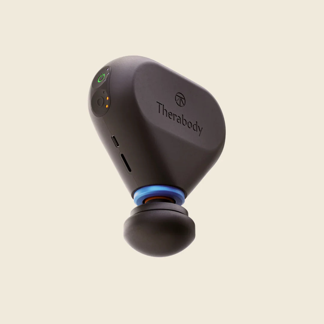 Black Therabody device on a beige background