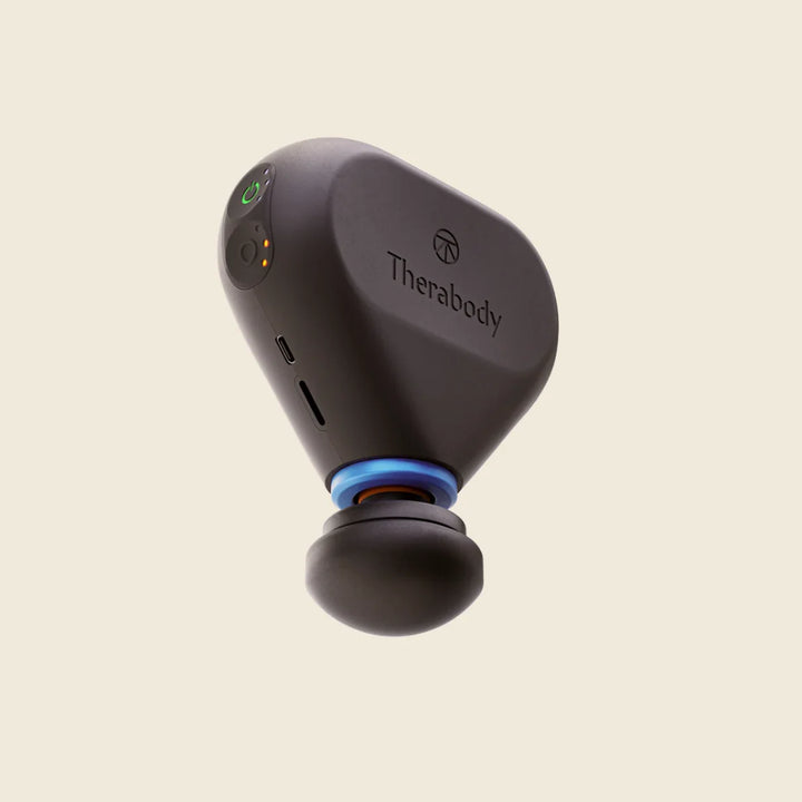 Black Therabody device on a beige background