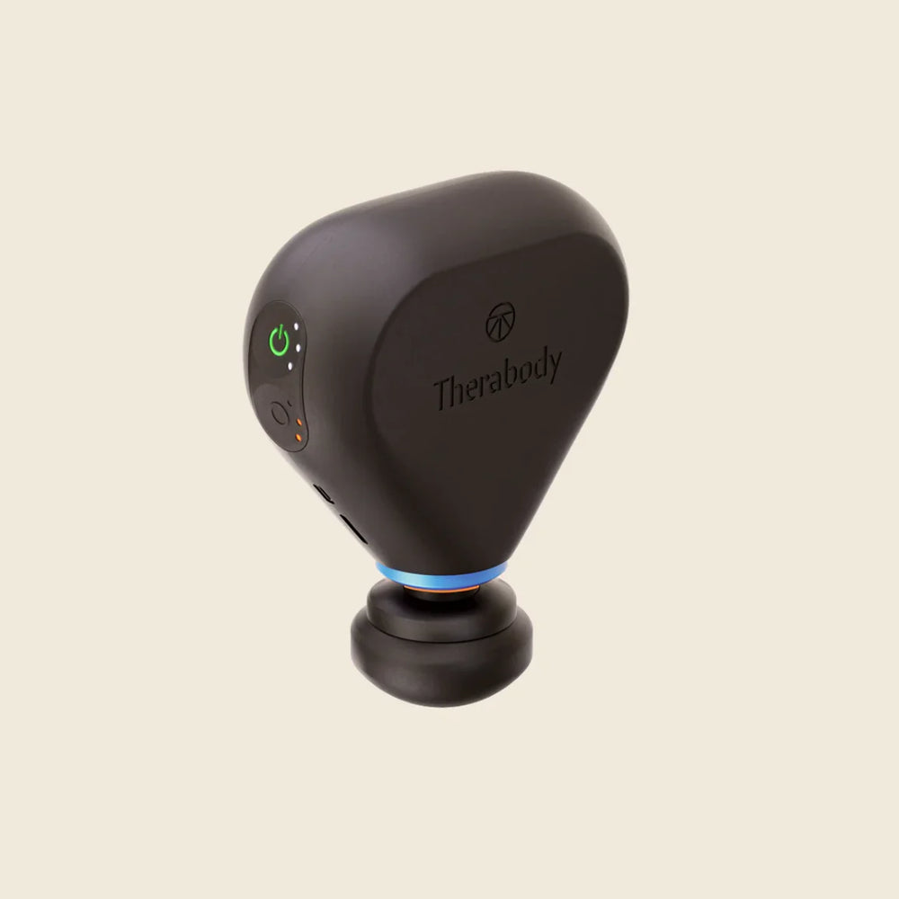 Black handheld device with Therabody branding on a beige background