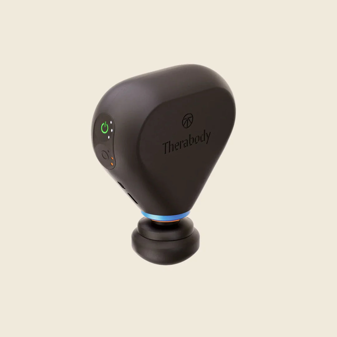 Black handheld device with Therabody branding on a beige background