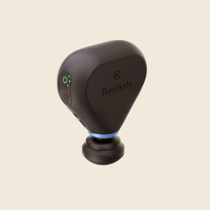 Black handheld device with Therabody branding on a beige background
